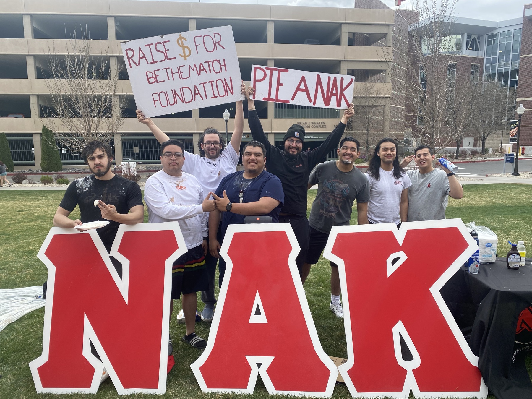 Omicron Chapter brothers behind the NAK letters on the UNR campus lawn